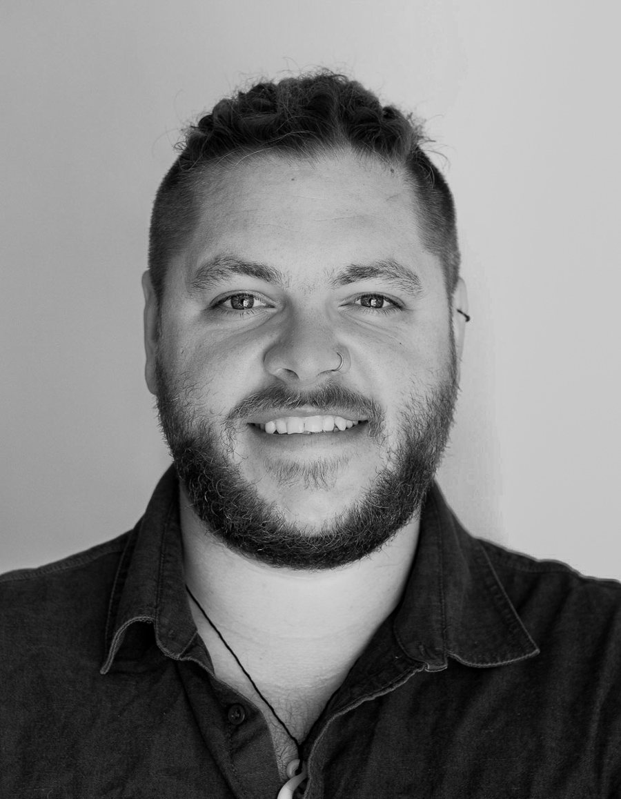 Jamie Hall, photographer and videographer, smiling in a black and white portrait